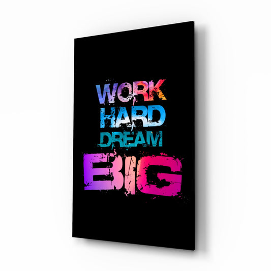 Black glass wall art panel displaying colorful gradient text reading "Work Hard Dream Big" with pink, blue, and purple lettering.