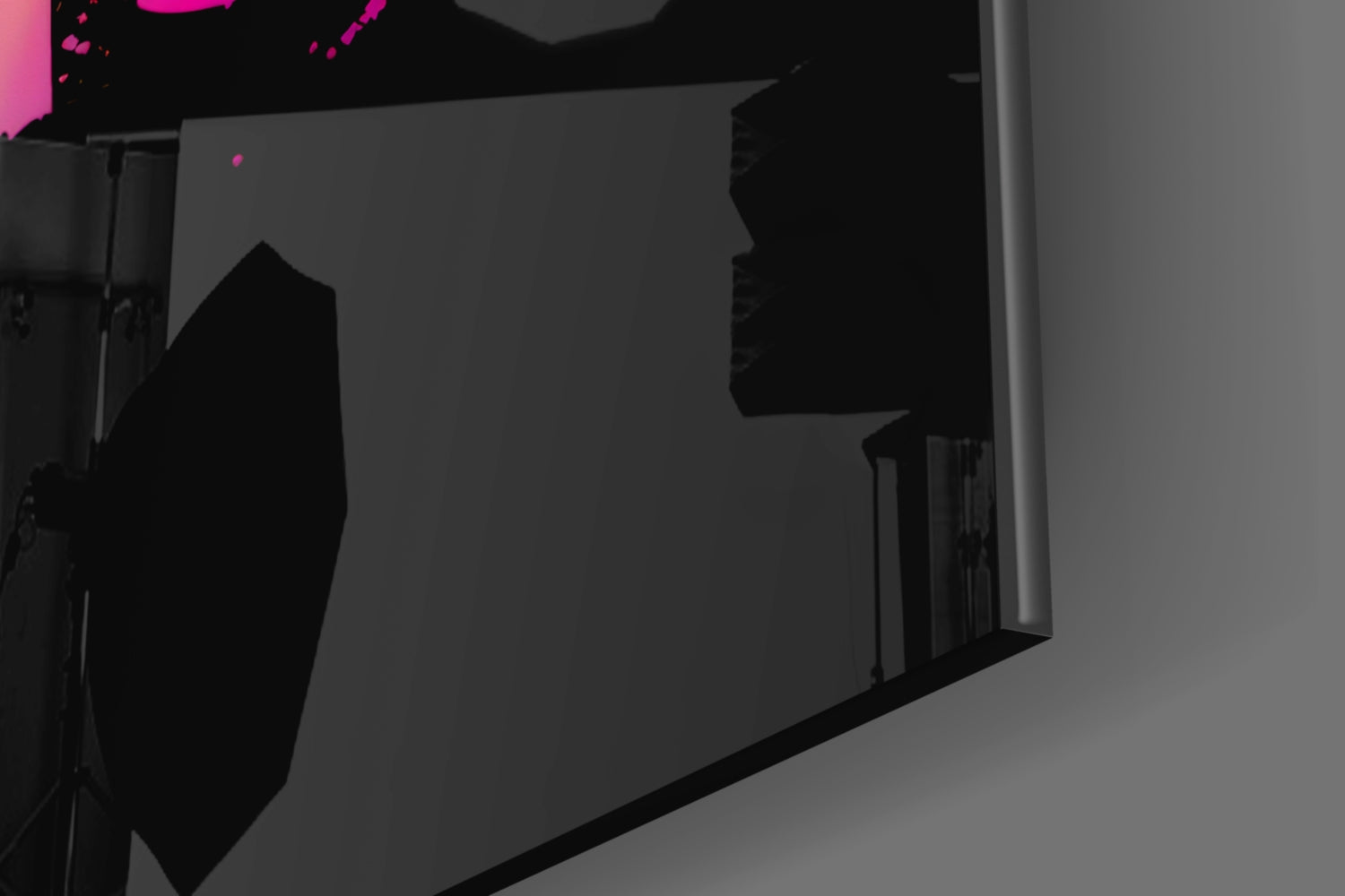 Dark silhouette of large glass wall art panel displayed indoors with magenta accent lighting visible at top.