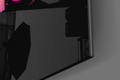 Dark silhouette of large glass wall art panel displayed indoors with magenta accent lighting visible at top.