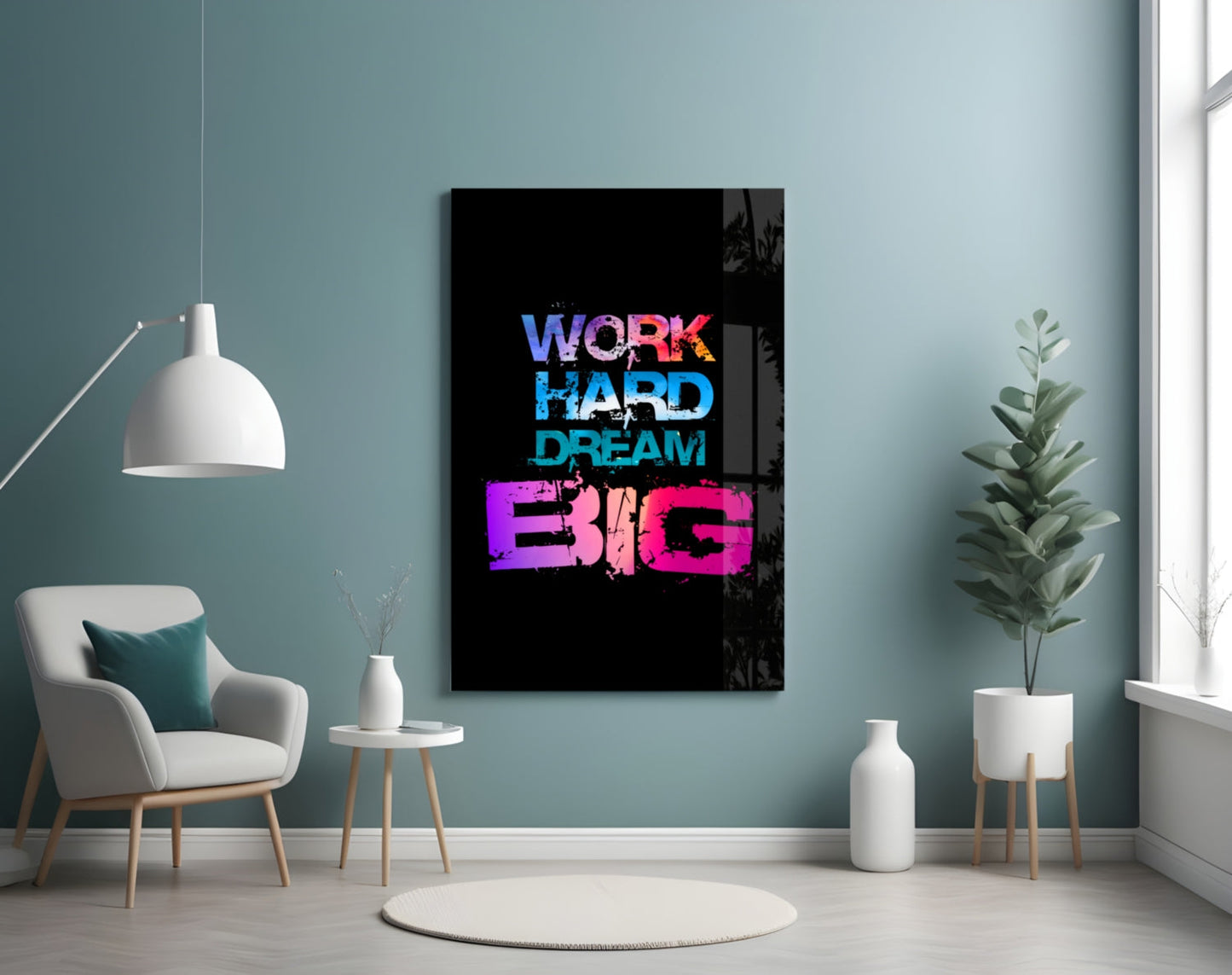Neon-style glass wall art displaying "WORK HARD DREAM BIG" in blue and pink text on black background, hung in modern room with teal walls.