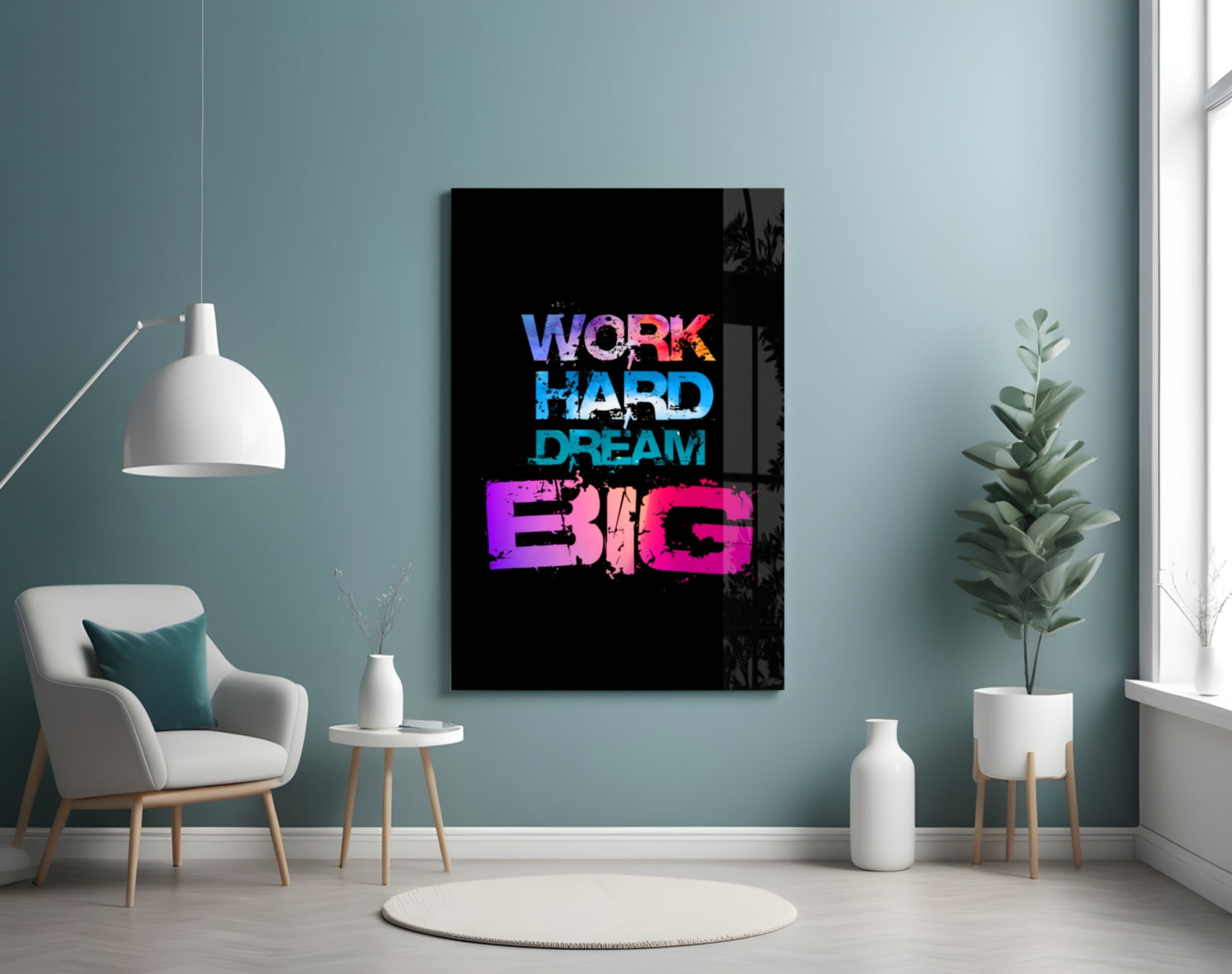 Neon-style glass wall art displaying "WORK HARD DREAM BIG" in blue and pink text on black background, hung in modern room with teal walls.