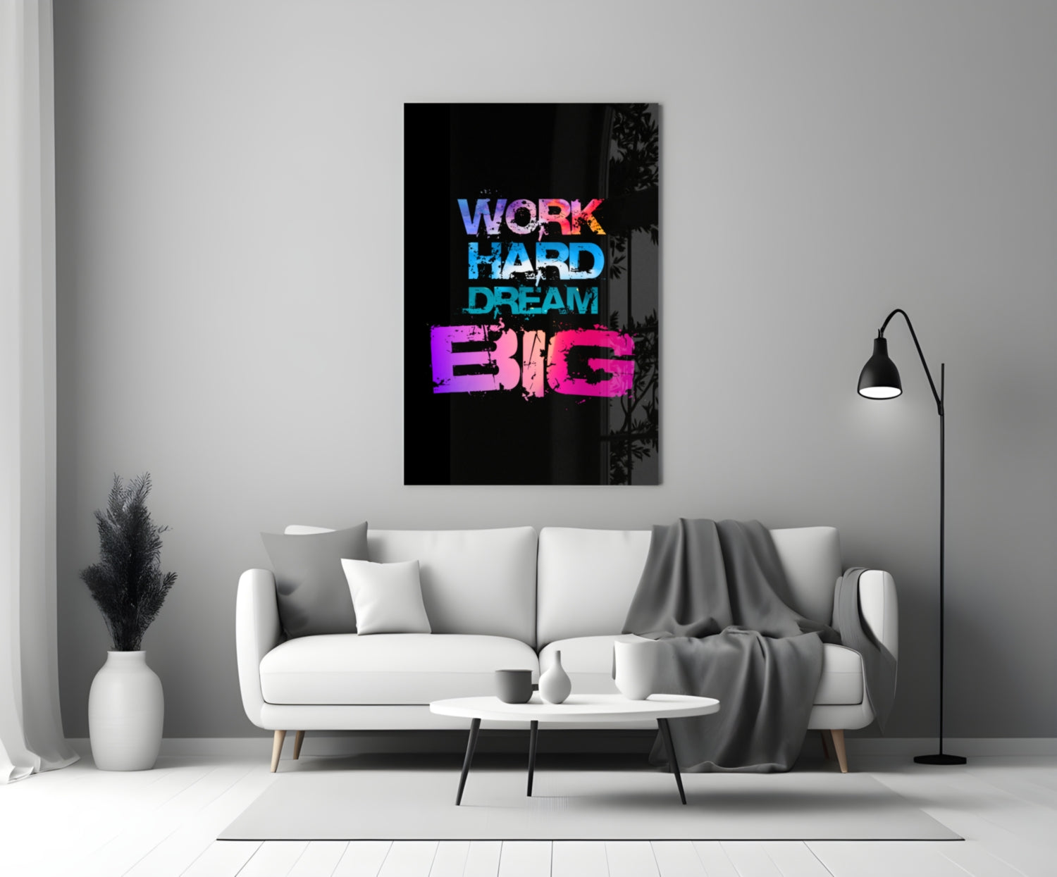 Neon glass wall art with "WORK HARD DREAM BIG" text in blue, cyan, and pink displayed above a white sofa in a modern living room.
