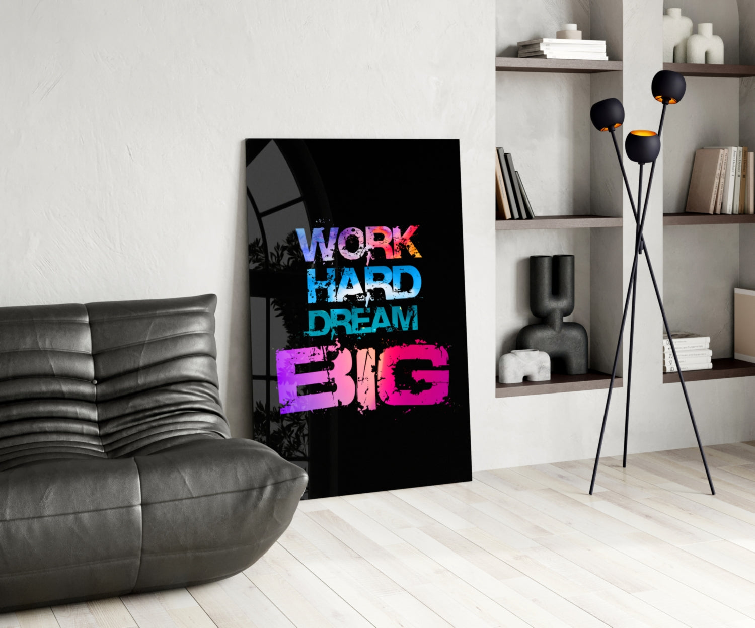 Black glass wall art displaying "WORK HARD DREAM BIG" in blue and pink neon-style text, displayed in a modern living room interior.