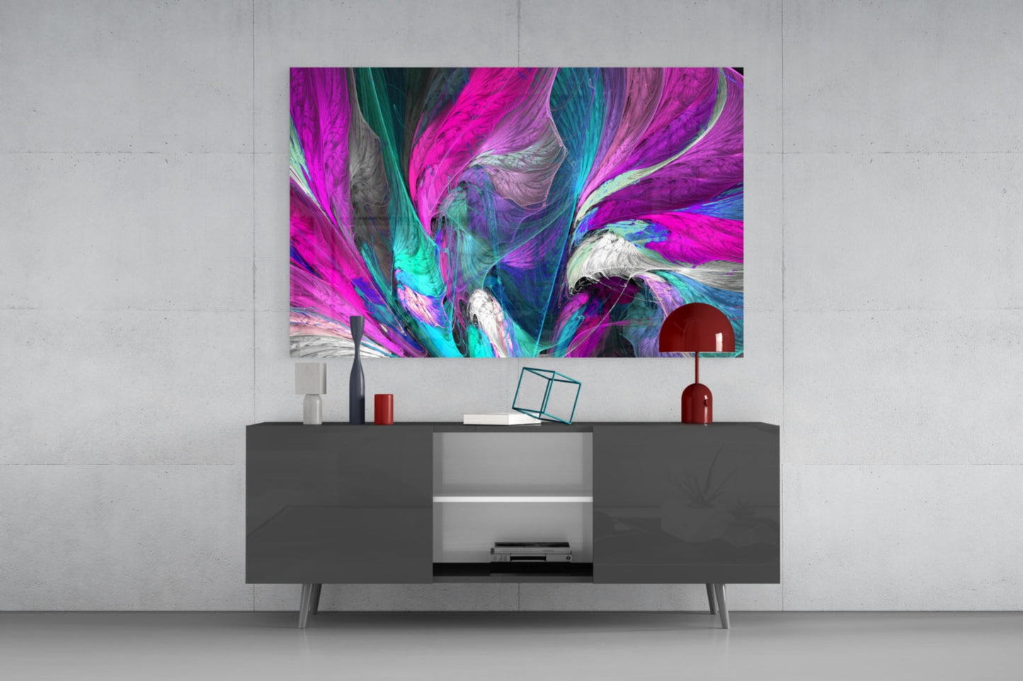 Vibrant abstract glass wall art in magenta, cyan, and white displayed above a dark media console in a modern living room setting.