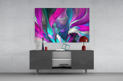 Vibrant abstract glass wall art in magenta, cyan, and white displayed above a dark media console in a modern living room setting.