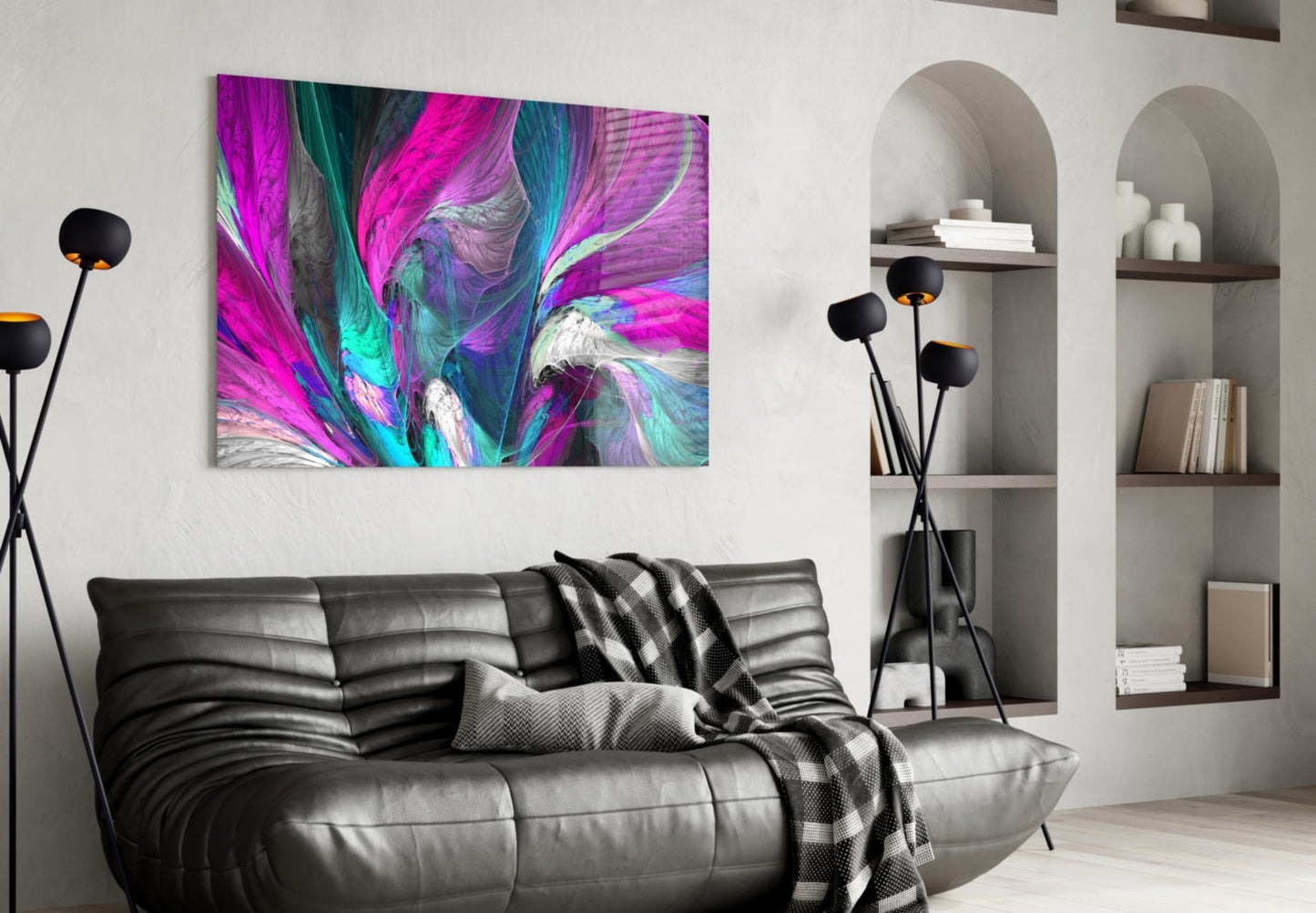 Vibrant pink, magenta, and teal abstract glass wall art displayed above a black leather sofa in a modern living room.