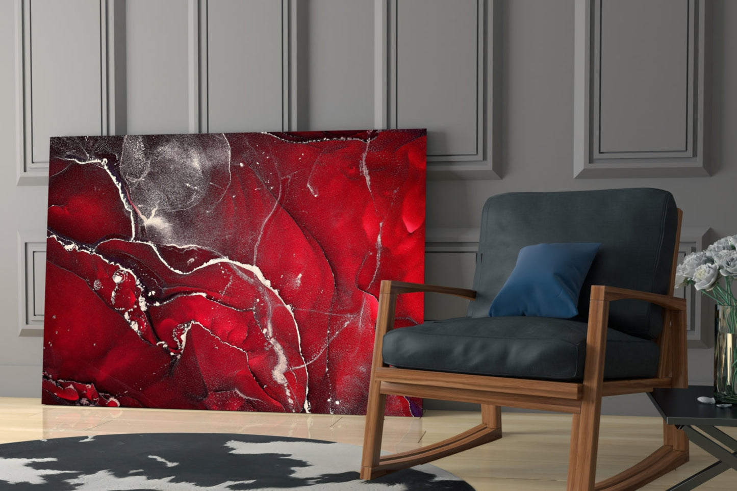 Red and gray marbled glass wall art panel displayed in a modern living room beside a wooden-framed chair with black leather and blue cushion.