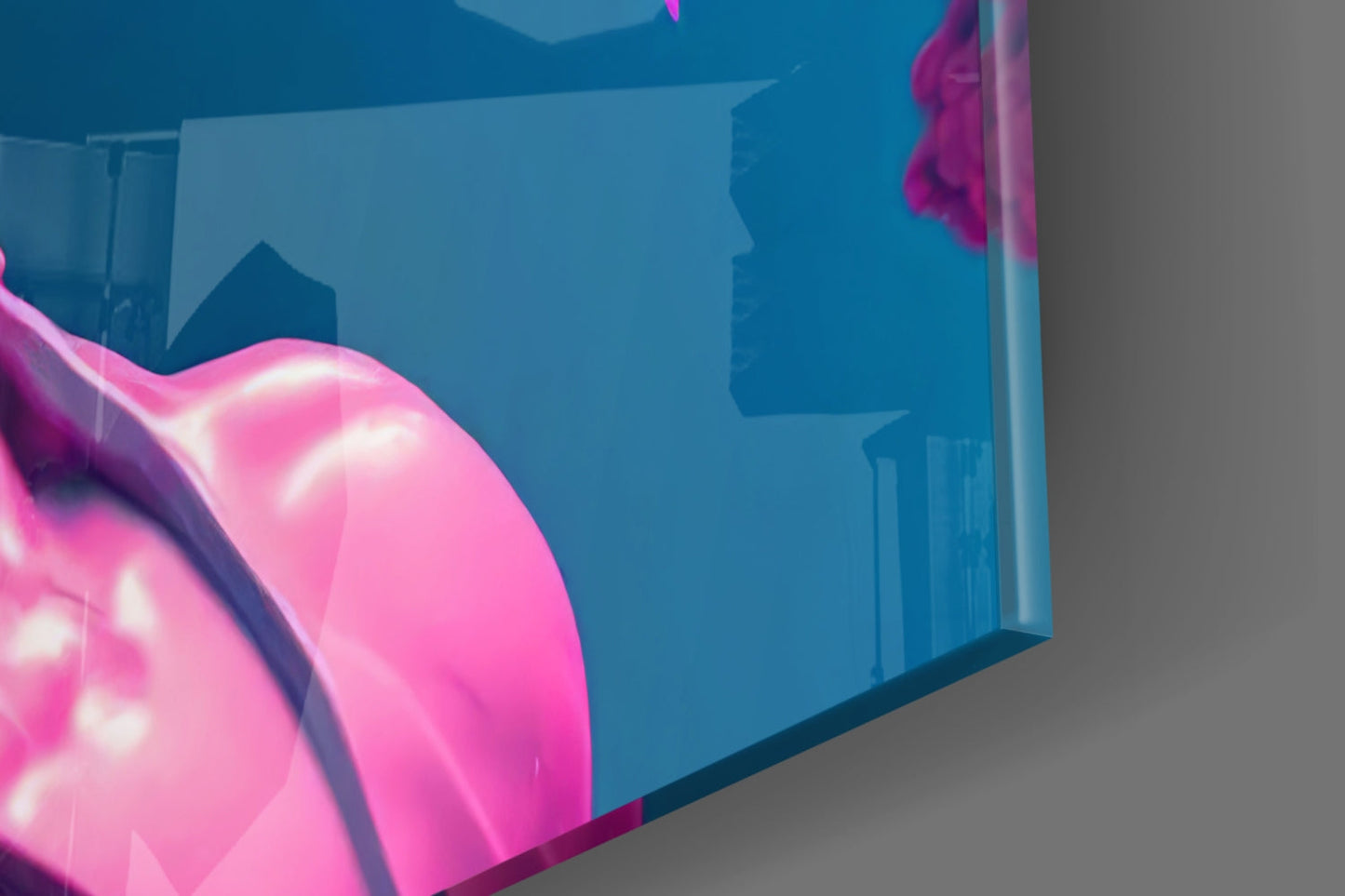 Close-up angled view of pink neon-lit glass sculpture against blue cityscape background, showing curved form and luminous details.