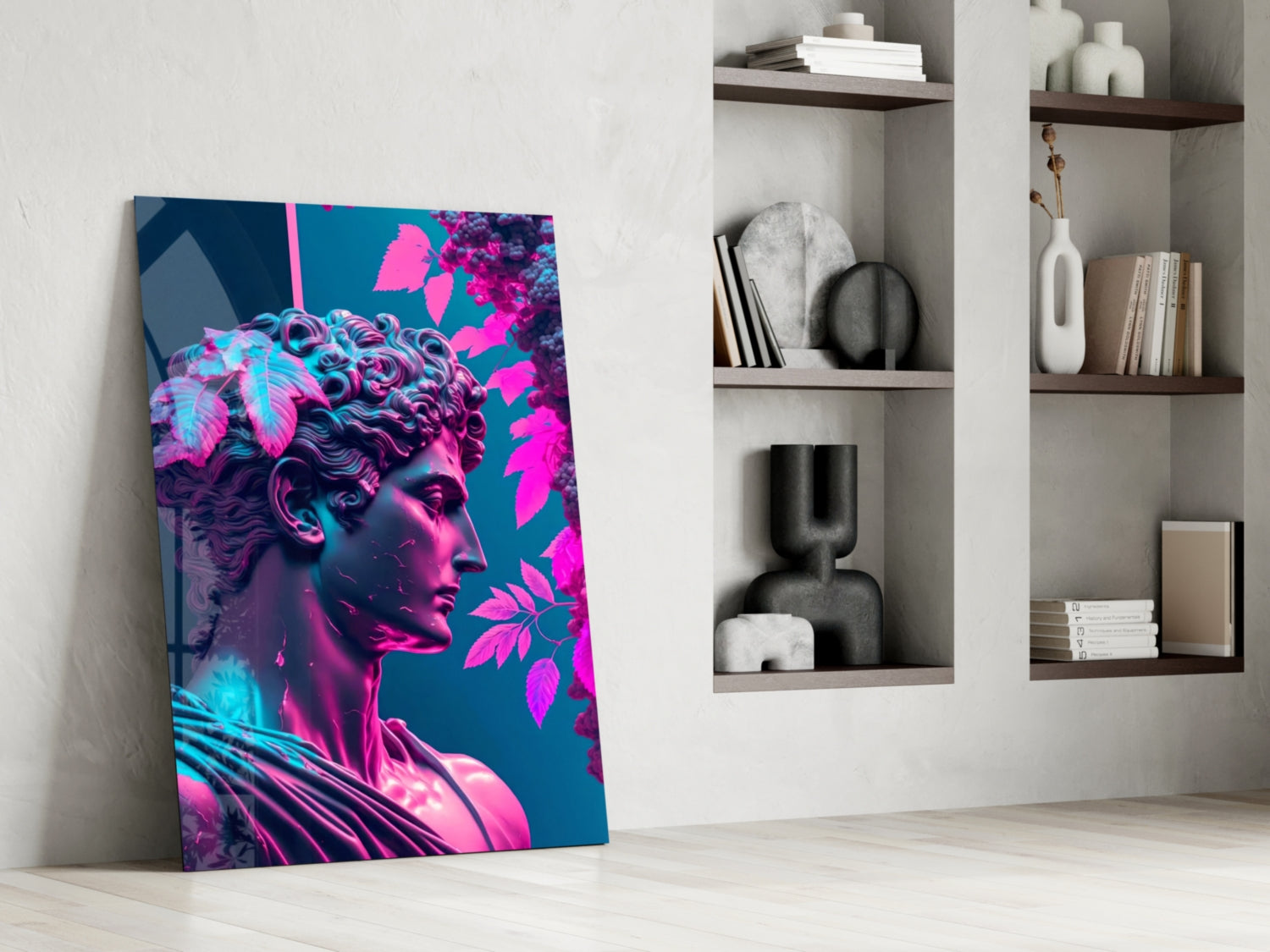 Vibrant neon pink and cyan glass wall art featuring a classical profile sculpture with magenta foliage against teal background, leaning against white wall beside shelving.