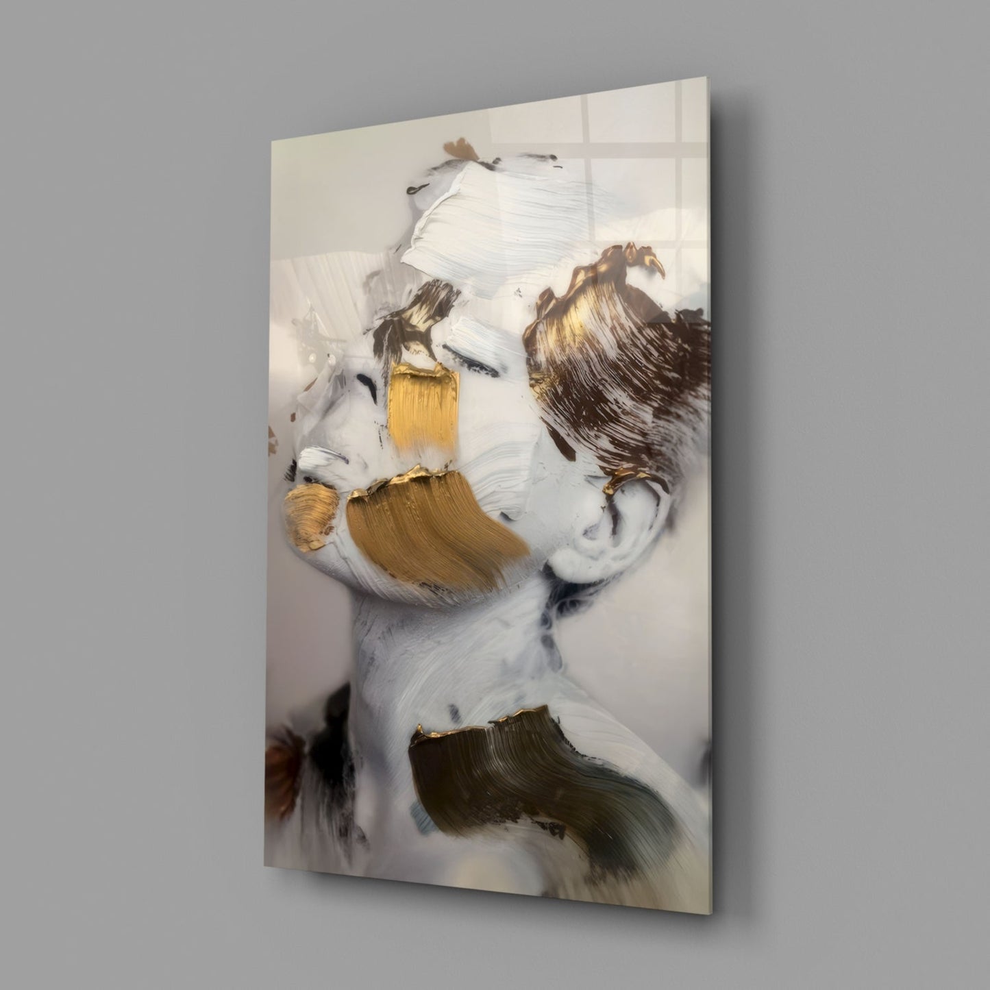 Abstract painted glass wall art featuring a stylized face with white, gold, and brown brushstrokes on cream background, displayed at angle.