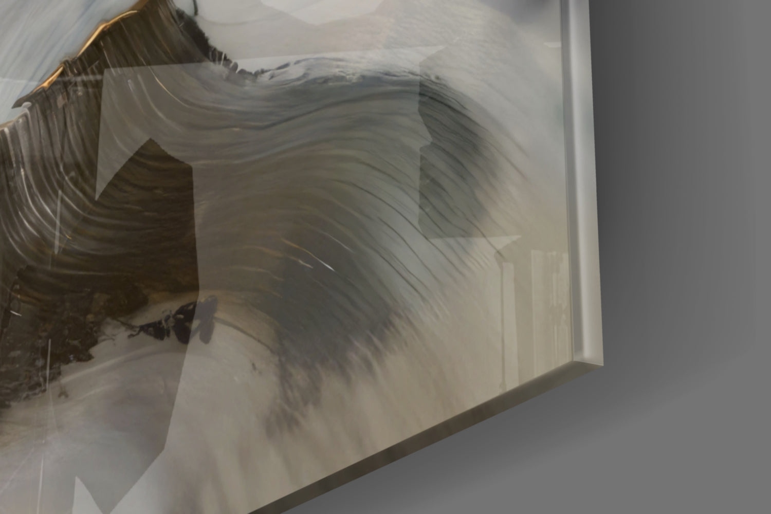 Close-up detail of brushed face glass art showing layered translucent panels with soft gray and white tones and subtle linear textures.