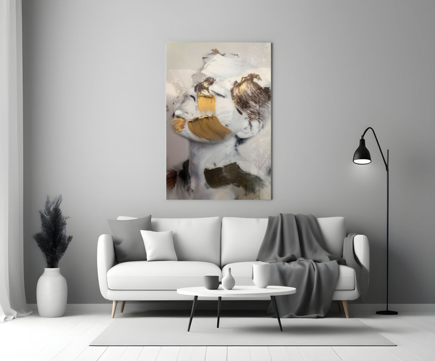 Abstract brushed face glass art with white, gold, and brown brushstrokes displayed above modern living room sofa.