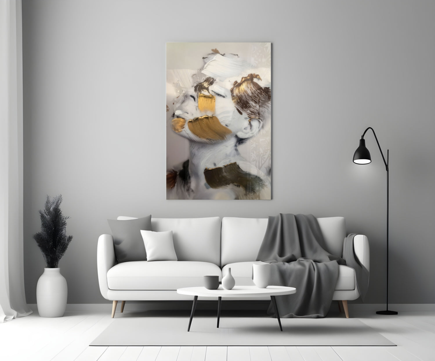 Abstract brushed face glass art with white, gold, and brown brushstrokes displayed above modern living room sofa.