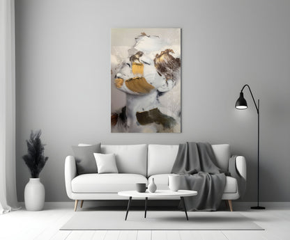 Abstract brushed face glass art with white, gold, and brown brushstrokes displayed above modern living room sofa.