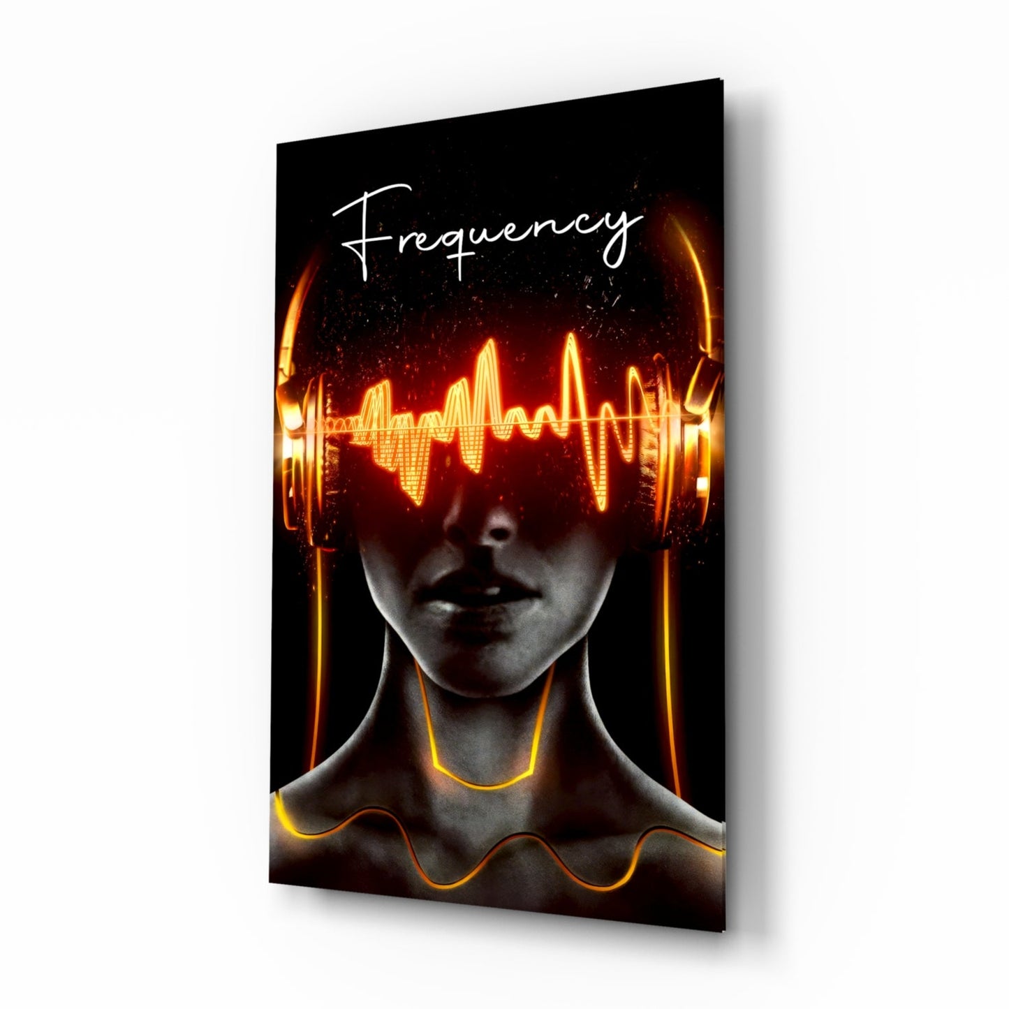 Angled view of glass wall art featuring a face with glowing neon yellow and orange soundwave graphics across the eyes and neon tubing around the neck against black background, with "Frequency" text at top.