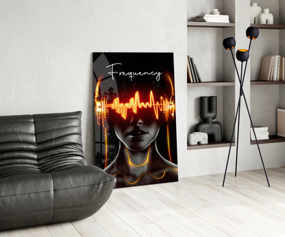 Modern living room displaying neon "Frequency" glass art featuring glowing yellow and orange sound waves over a silhouetted face wearing headphones.