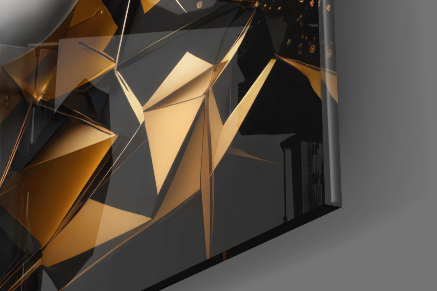 Close-up angled view of golden and black geometric glass panels with translucent faceted surfaces casting warm light shadows.