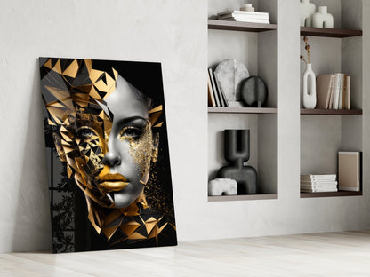 Golden Face Glass Wall Art leaning against white wall beside floating shelves with decorative objects and books.