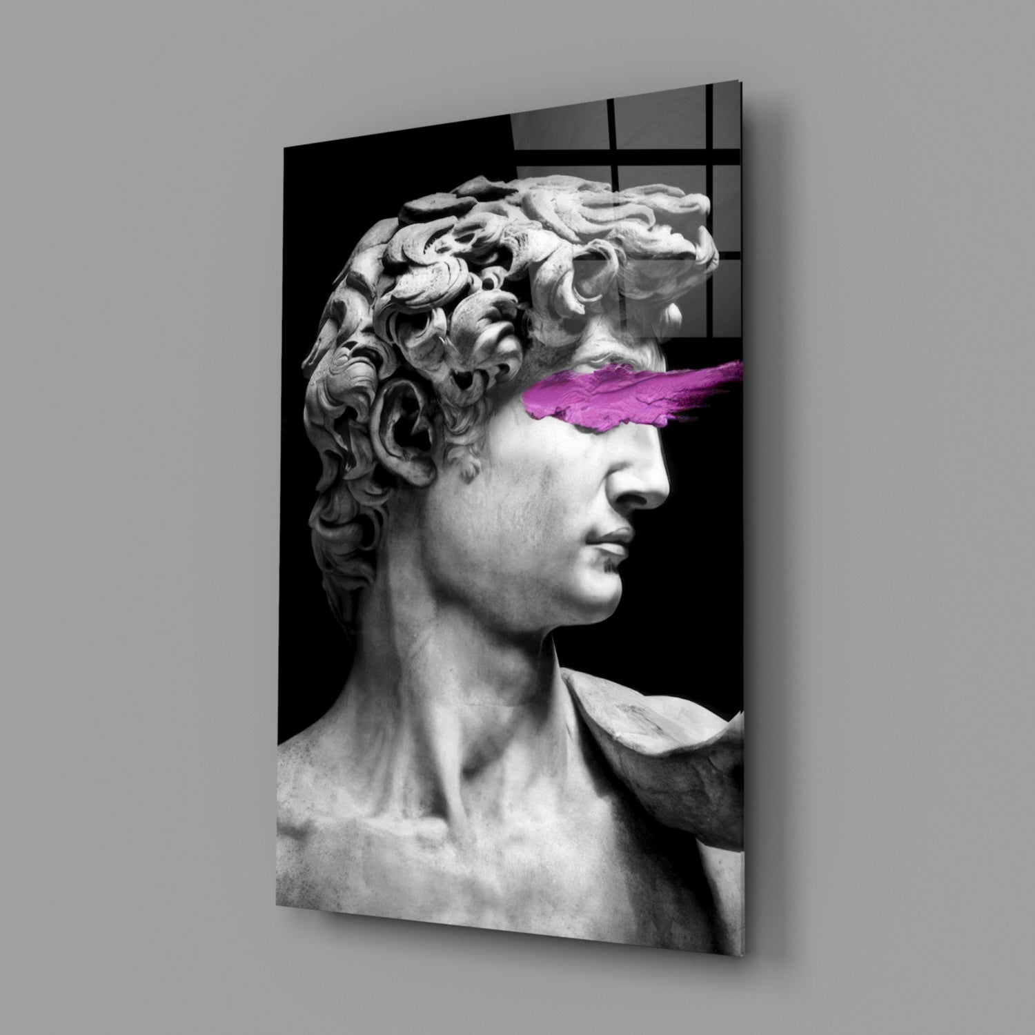 Classical marble bust in profile with magenta brushstroke across eyes, mounted on glass wall panel against gray background.