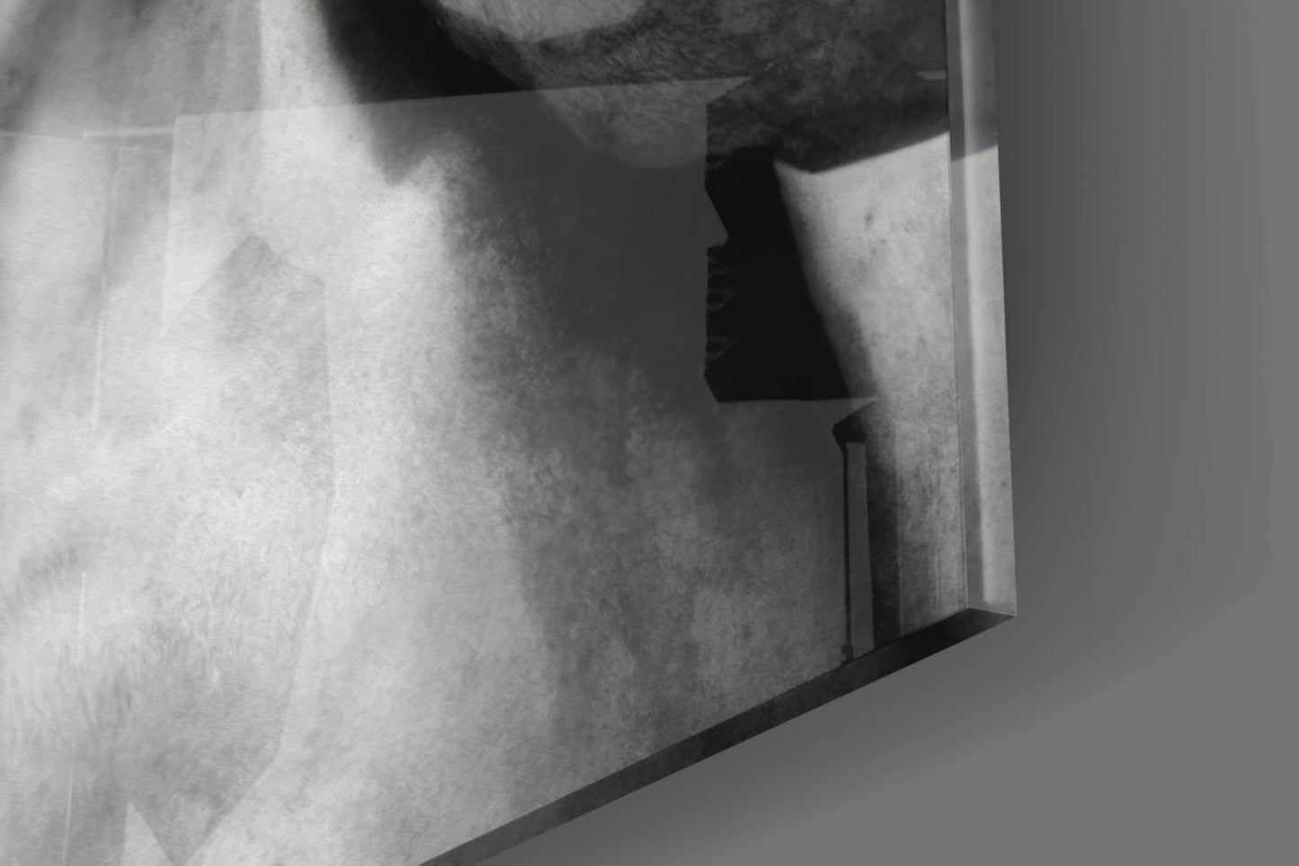 Close-up detail of textured glass wall art showing layered translucent planes with dramatic shadows in grayscale.