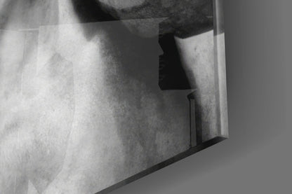 Close-up detail of textured glass wall art showing layered translucent planes with dramatic shadows in grayscale.