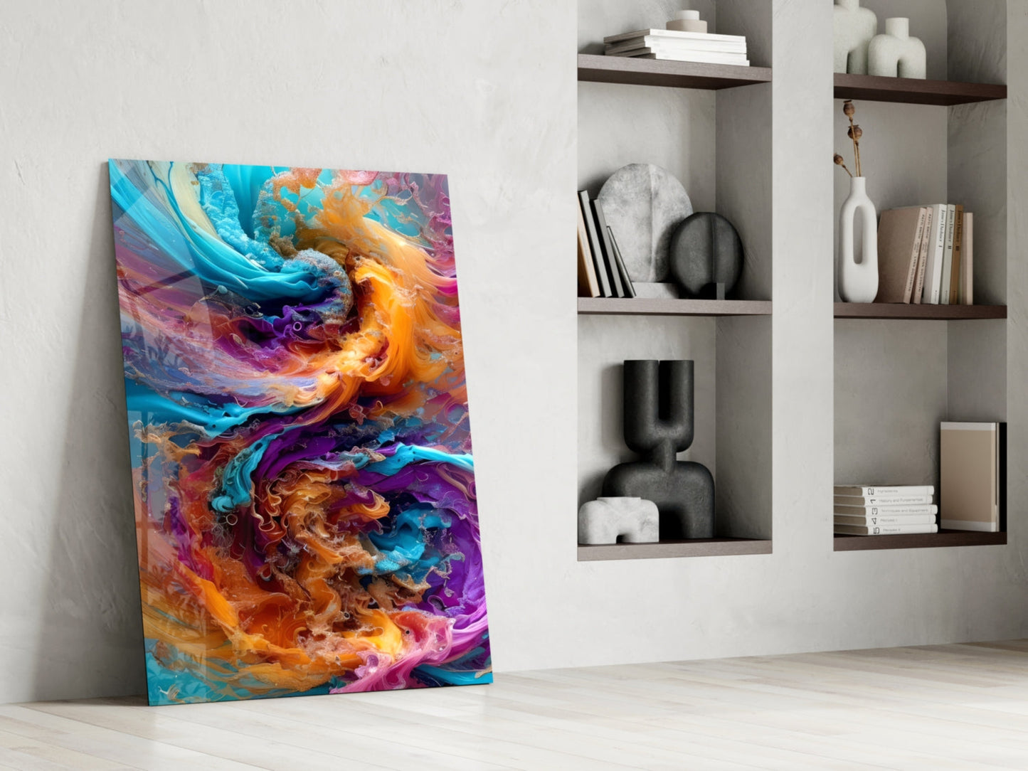 Colorful abstract glass art leaning against white wall beside shelving unit with decorative objects and books.