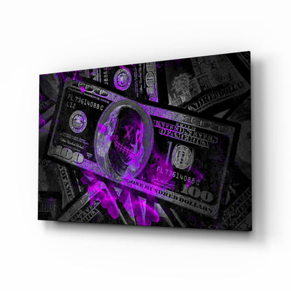 Angled perspective view of glass wall art featuring neon purple-lit $100 bills with skull imagery on black background.