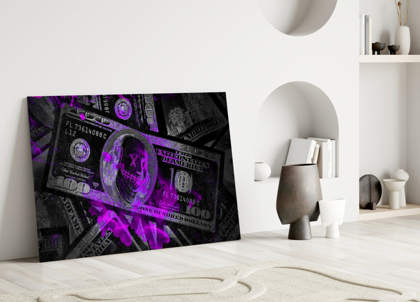 Purple neon illuminated hundred dollar bills glass wall art leaning against white interior wall with decorative objects.