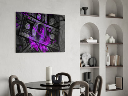 Purple neon-lit dollar bill glass wall art displayed above a black dining table in a modern interior setting.