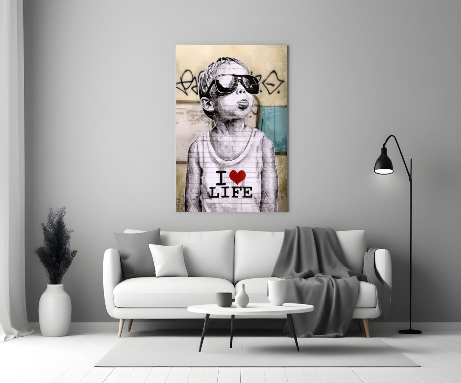 Glass wall art depicting a child wearing sunglasses and "I Love Life" shirt displayed above a white sofa in a modern living room.