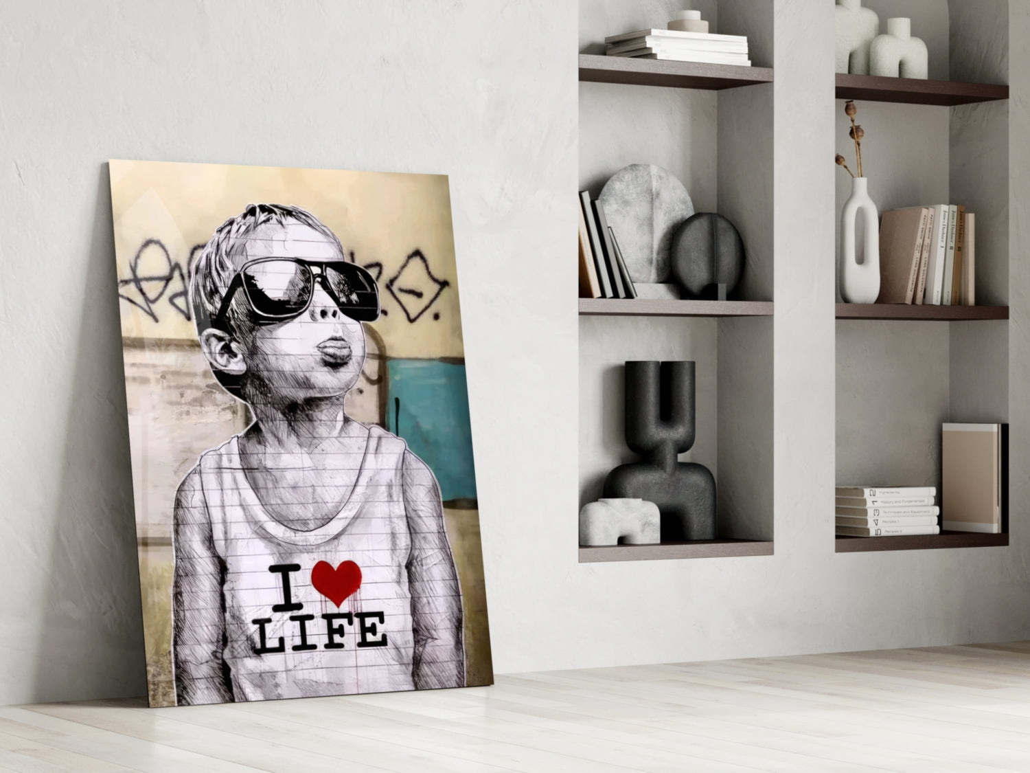 Glass wall art leaning against white wall displaying sketch-style child wearing sunglasses and "I ❤ LIFE" text on shirt, with shelving unit behind.