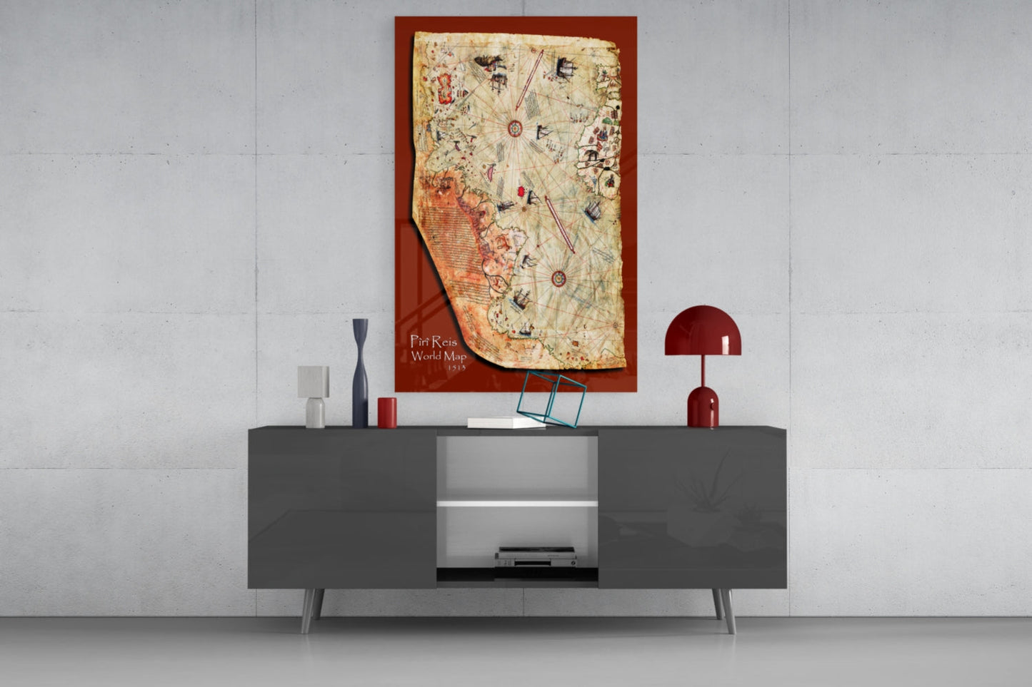 Glass wall art of the Piri Reis 1515 world map displayed above a dark gray media console with decorative accessories.