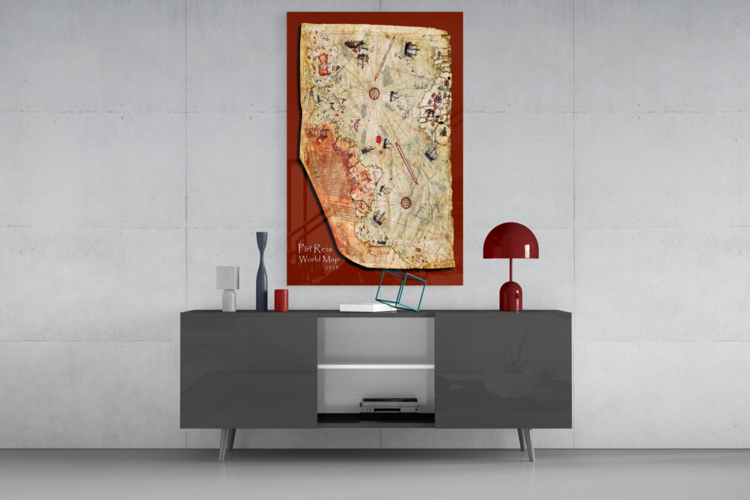 Glass wall art of the Piri Reis 1515 world map displayed above a dark gray media console with decorative accessories.