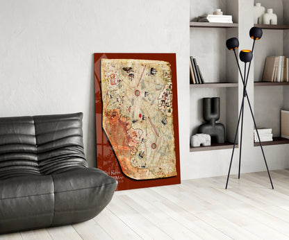 Modern living room interior featuring a Piri Reis Map artwork with red border and antique parchment design leaning against white wall next to black leather chair.