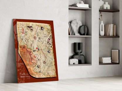Red-framed glass wall art displaying the Piri Reis World Map from 1513, leaning against white wall beside built-in shelving.