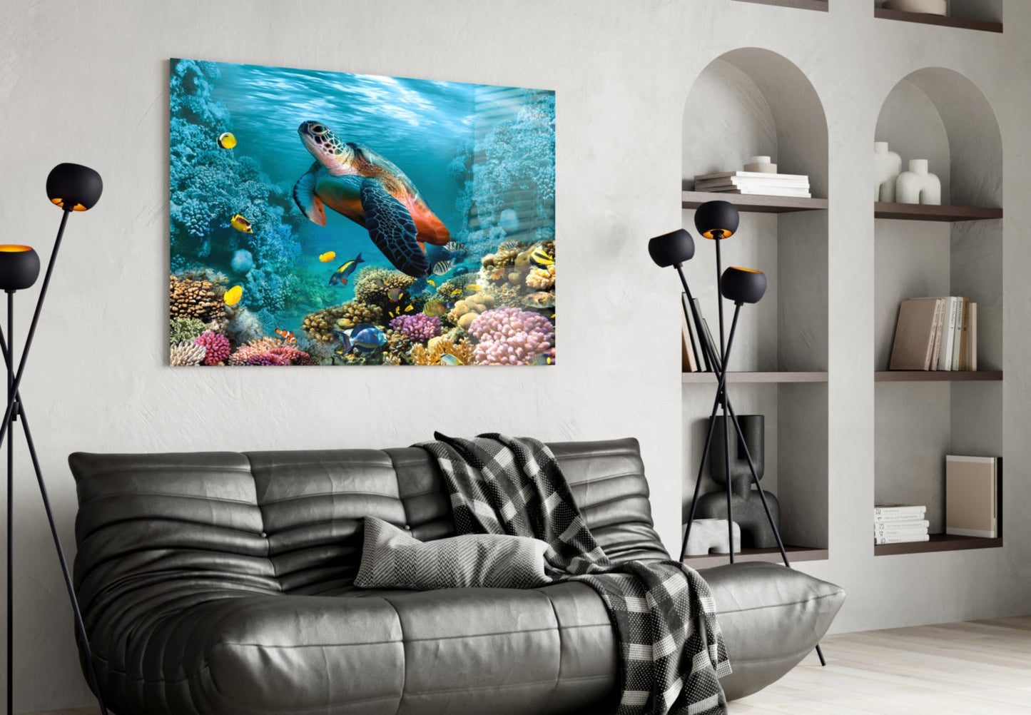 Underwater Glass Wall Art depicting a sea turtle swimming among colorful coral reef and tropical fish in turquoise water, displayed above a black sofa in a modern living room.