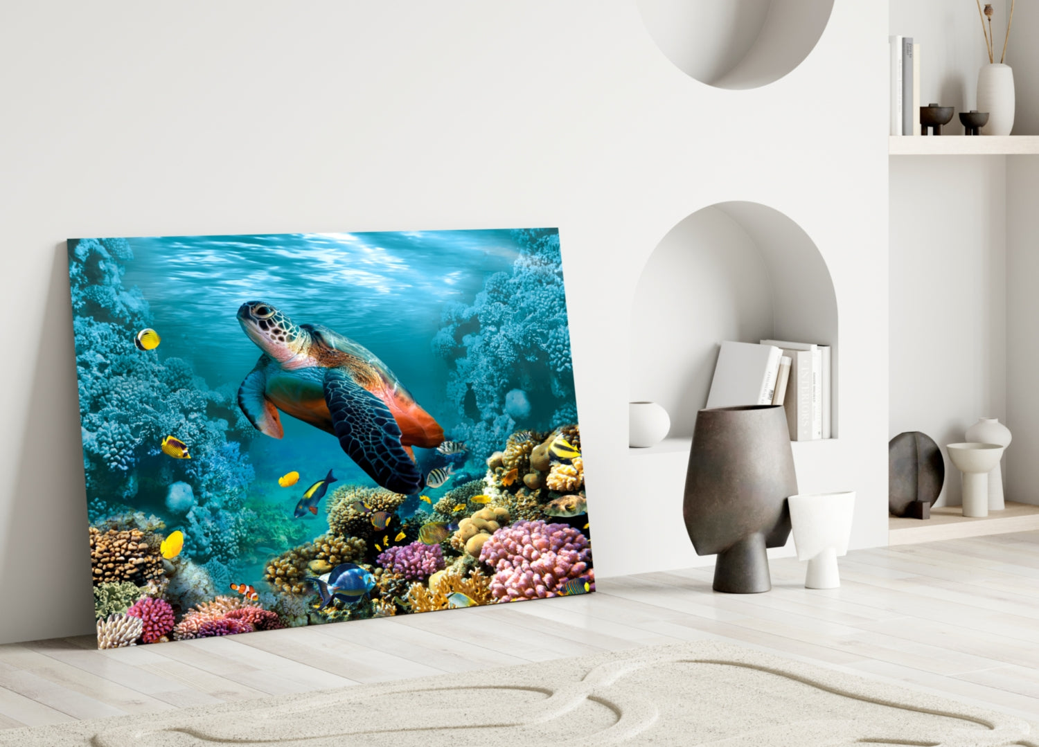 Vibrant glass wall art leaning against white wall displays underwater sea turtle surrounded by colorful coral reef and tropical fish.
