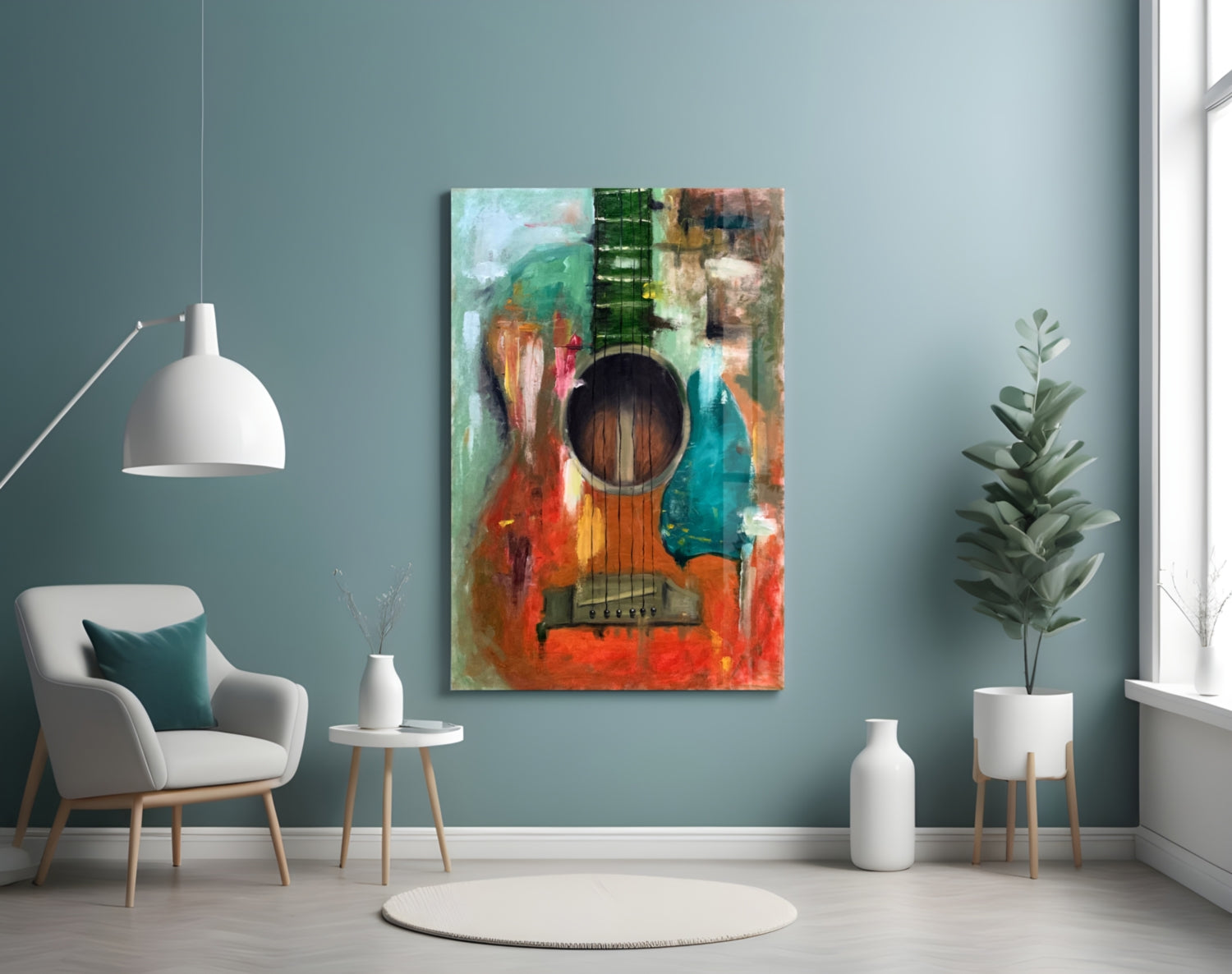 Colorful abstract guitar artwork displayed on teal wall above white chair in minimalist interior setting.