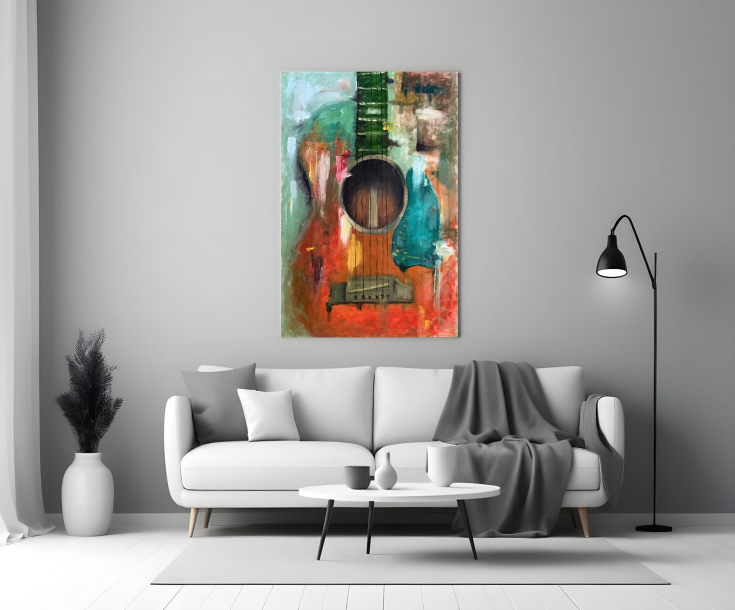 Colorful abstract guitar glass wall art displayed above a white sofa in a minimalist living room setting.