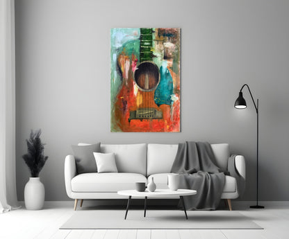Colorful abstract guitar glass wall art displayed above a white sofa in a minimalist living room setting.