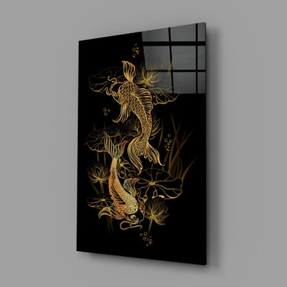 Angled view of black glass panel with gold koi fish and lotus flowers design, mounted on gray wall.