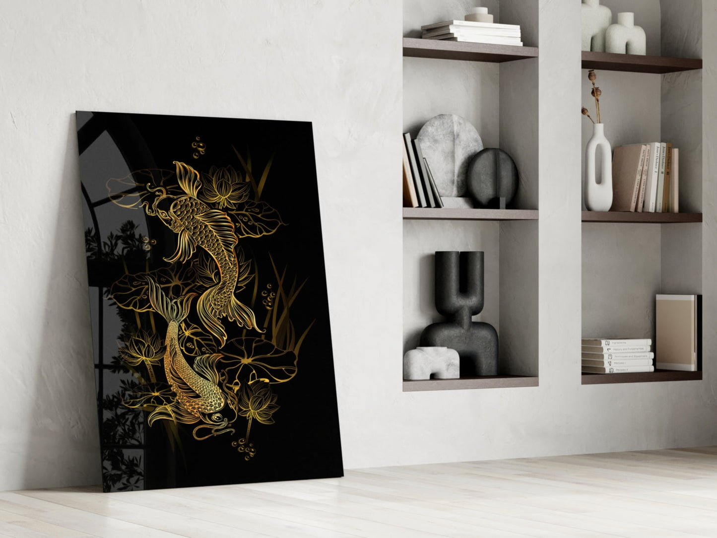 Black glass panel with gold yin-yang koi fish design leaning against white wall beside built-in shelving.
