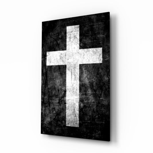 White Christian cross on distressed black background, displayed as angled glass wall panel with shadow.