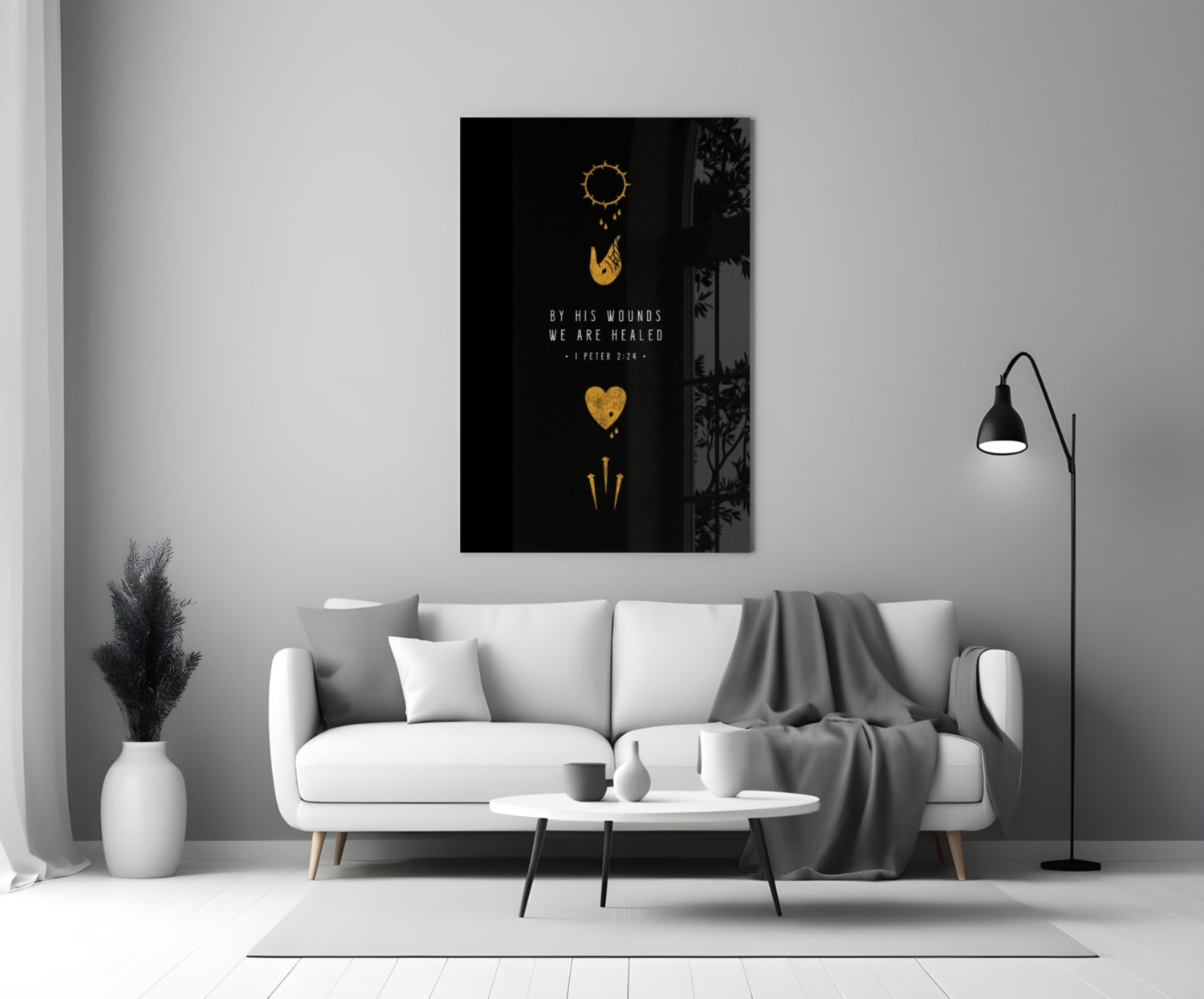 Black glass wall art with gold religious symbols and "By His Wounds We Are Healed" text displayed above white sofa in modern living room.