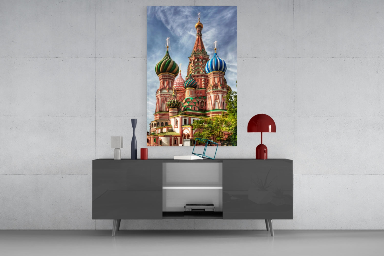 Saint Basil's Cathedral glass wall art displayed above a gray media console with decorative accessories in a modern interior setting.