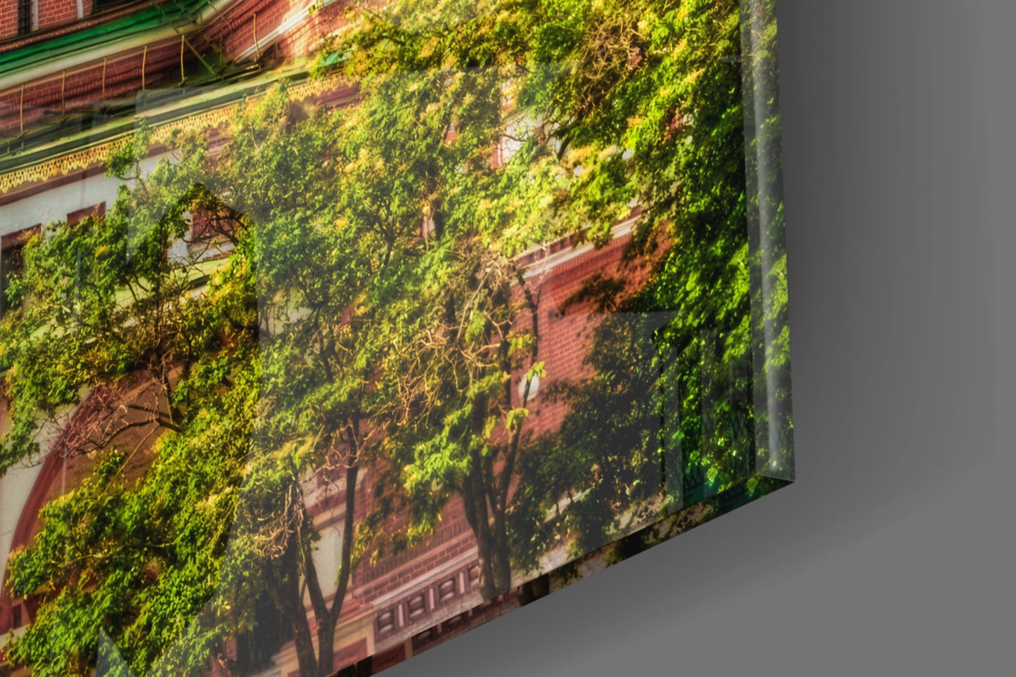 Glass wall art displaying ivy-covered red brick building facade at angled perspective against gray background.