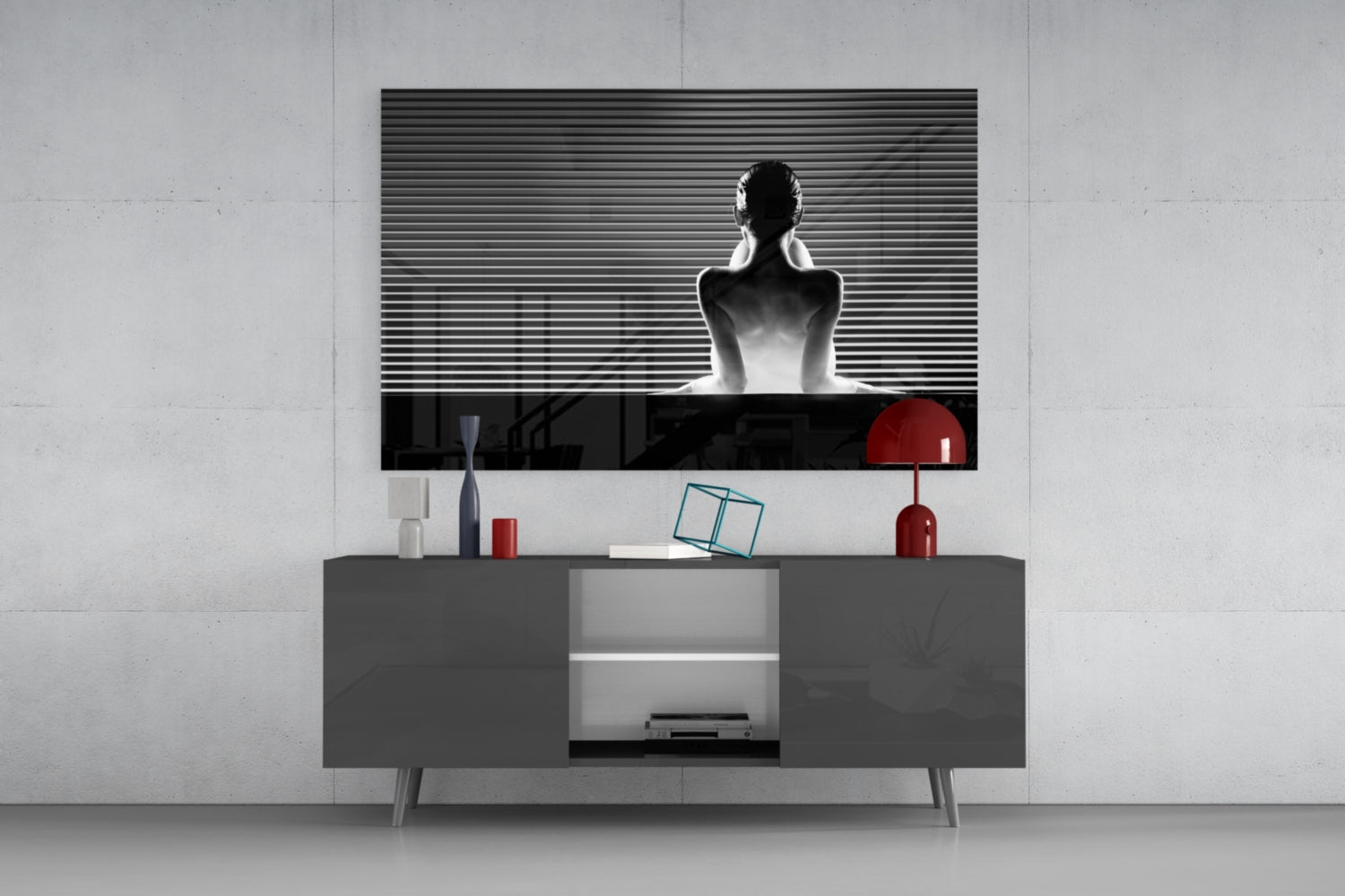 Black and white glass wall art featuring a seated figure with horizontal lines, displayed above a gray media console with red decorative accents.
