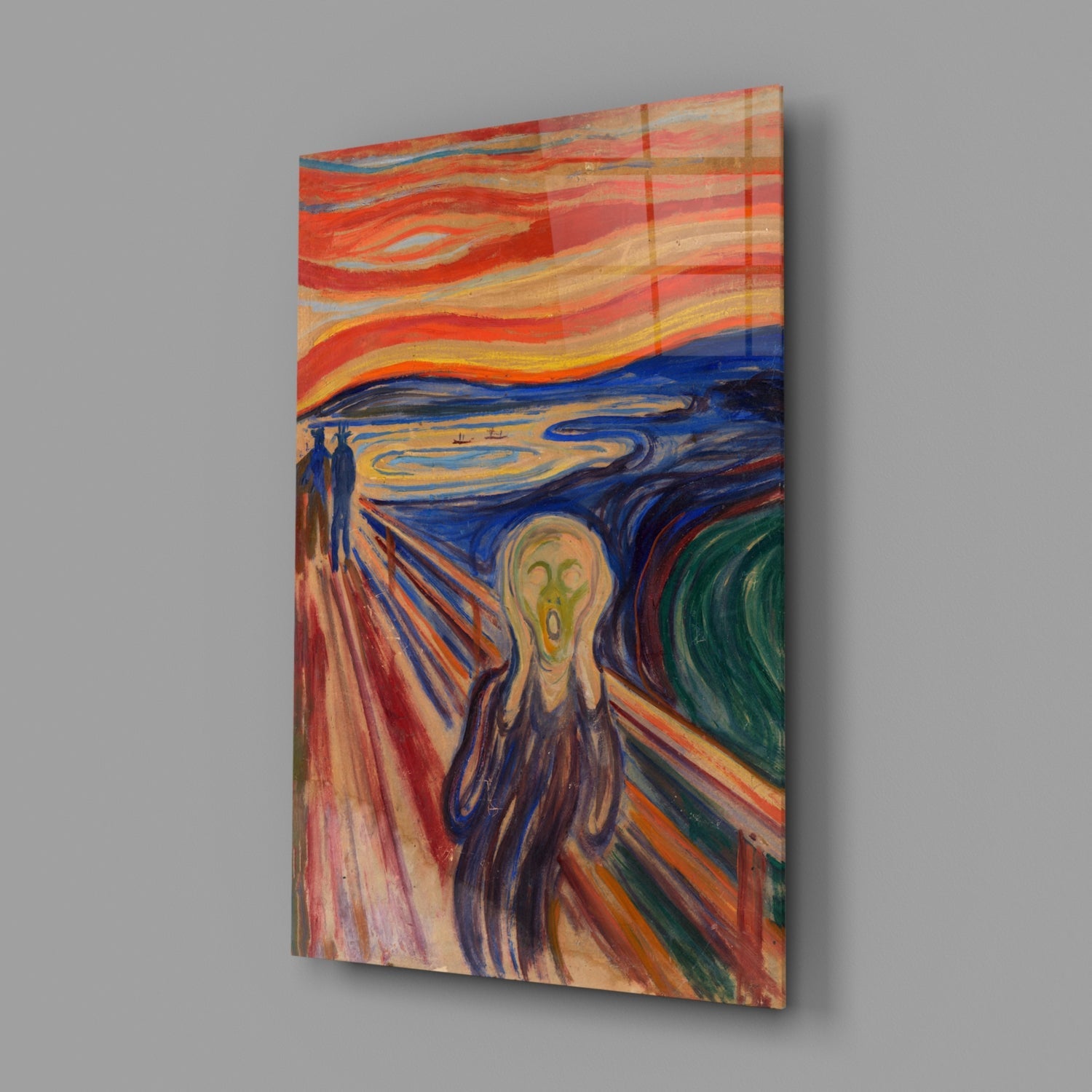Glass wall art print displaying "The Scream" painting mounted at angle against gray background, showing vibrant swirling reds, blues, and yellows.