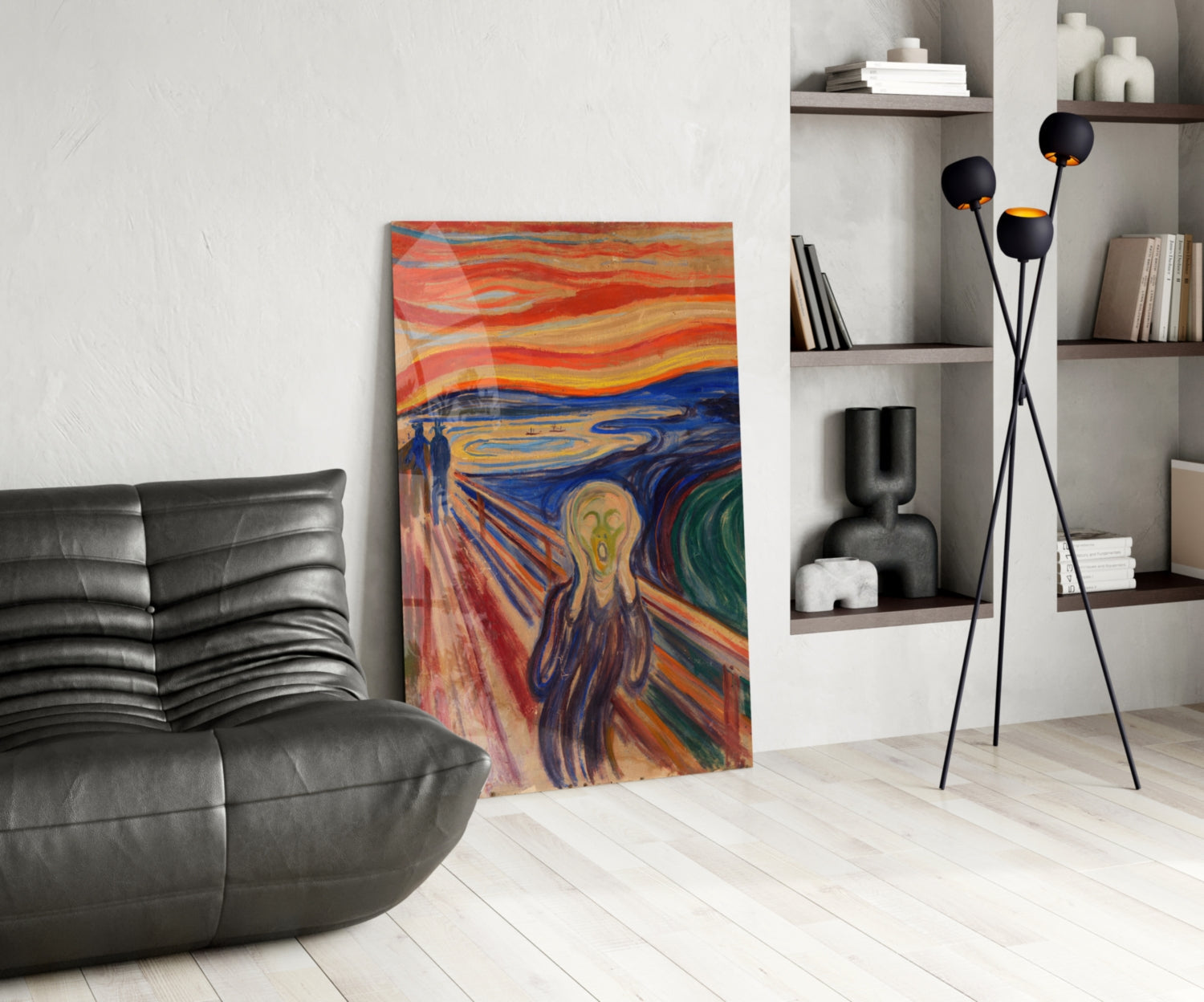 Colorful glass art print of "The Scream" displayed in modern living room with black leather chair, floor lamp, and wall shelving.