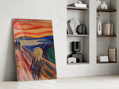 Colorful "Scream" glass wall art leaning against white wall beside modern shelving with decorative objects.